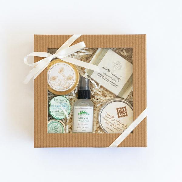 Clear lid gift box with spa essentials and California candle tied with ribbon